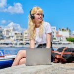 Female teenager in headphones with laptop sitting near water, sea harbor with boats. Teenage student with headphones studying using laptop. Summer, education, knowledge, youth, back to college concept SSUCv3H4sIAAAAAAAACnRSy27DIBC8V+o/WJxtyRg/e636BW1PVQ8YNjYKgQhwqijKvxeM3XJob+wMO7OzcHt8yDI0UisYespuofK1kHKxzlAntPJwmW+4AcXBpMjFkLZMAeDCaSOoTMGROjYregIPqkXKAN9XEllH3WLBBvcNYtTB5DUi+CMRR/yIdbYTK+k7PIXewLtoqacryhPWLmNg0Q5Fm380XvjCYu4/JF7ZrLXMs2ctJUyQZ+9KXMBY4a4ZOPbrEA+fe346gWLXNWIS3YAEGqNvqRDva2gqQoqSD01RD+Wh6FtOikNXkbFvoG0xXV2iNDp+OTCndHl04UIne7toRmW4QBLnsxFMqClp025eH3ZvY3pRzoSRUYWHfRdIan2mowzvePCysOMztdZ38B1PvJj/SfqUWCnt1swoqiLunzuUmFR9W+GyIQOumq6r6+1C/CKz8DrrRLuQr9lR8DS9CBOgnpT4AAMuWiC8qCsORY87Vowda5uO47rswhbv3wAAAP//AwDwRwGe/QIAAA==
